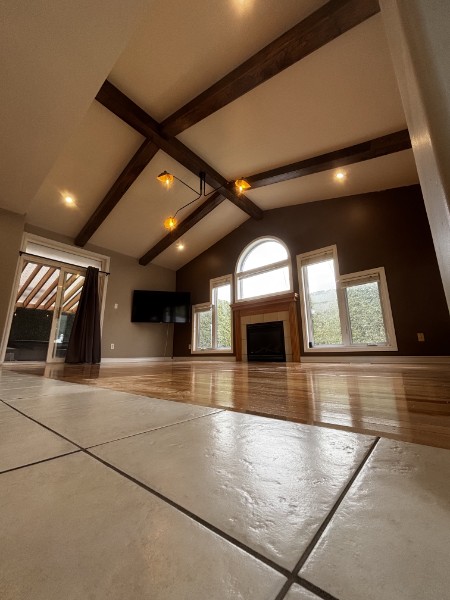 Custom great room with vaulted ceiling and exposed wood beams